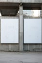 two white signs on a concrete wall