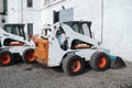 Two white skid steer loader at a construction site waiting of work. Industrial machinery. Industry. Royalty Free Stock Photo