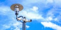 Two white surveillance cameras on the metal street light lamp post outdoor on blue sky background Royalty Free Stock Photo