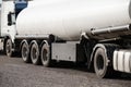 Two white tank trucks on the road, clear and blank space on the cistern side Royalty Free Stock Photo