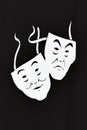 Two white theater masks a comedy and tragedy on a black background. The concept of theatrical art Royalty Free Stock Photo