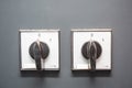 Two white toggle switches 0-1 on a gray wall. Close-up. Horizontal orientation. Royalty Free Stock Photo