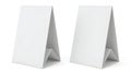 Two white triangular stand-up paper bags displayed side by side against a plain background Royalty Free Stock Photo