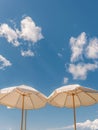 Two White Umbrellas on Sandy Beach Royalty Free Stock Photo