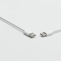 Two white USB cables with Type-A connectors are positioned facing each other on a Royalty Free Stock Photo