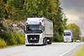 Two White Volvo Semi Trailer Trucks on Road