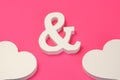 Two White Wooden Heart And Ampersand Symbol On Pink Background