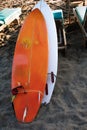 Two white and yellow surf boards lying on sandy beach by ocean..Bali.Indonesia. Surf boards on sandy beach for rent. Surf lessons Royalty Free Stock Photo