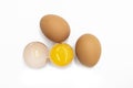 Two whole eggs and one broken isolated on a white background Royalty Free Stock Photo