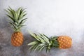 Two whole fresh ripe pineapples on concrete background. Food background. Top view, copy space