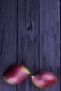 Two whole mangoes on wooden background. Royalty Free Stock Photo