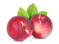 Two whole of nectarine peach with green leaves Royalty Free Stock Photo