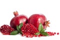 Two whole and part of a pomegranate with pomegranate seeds Royalty Free Stock Photo