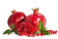 Two whole and part of a pomegranate with pomegranate seeds Royalty Free Stock Photo