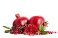 Two whole and part of a pomegranate with pomegranate seeds Royalty Free Stock Photo