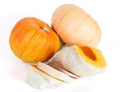 Two whole pumpkins and pieces of pumpkin on a white background Royalty Free Stock Photo