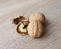 Two whole walnuts and one cracked walnut Royalty Free Stock Photo