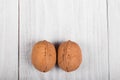 two whole walnuts on wooden background, healthy brain food, walnut on light vintage table Royalty Free Stock Photo