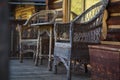 Two wicker chairs and table on veranda, closeup shot. Wicker furniture in garden exterior Royalty Free Stock Photo