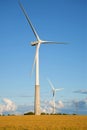 Two wind electric generators in the field in the summer evening. Estonia Royalty Free Stock Photo