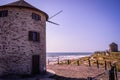 Two windmills on the dunes of ApÃÂºlia beach with a wooden fence and cordon delineating the walkway, Esposende PORTUGAL Royalty Free Stock Photo