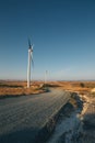 Two windmills by roadside in a rural landscape in Cyprus