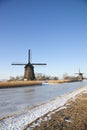 Two windmills in winter time with snow Royalty Free Stock Photo