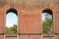 Two through window embrasures in the old brick wall of an ancient house Royalty Free Stock Photo