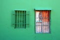 Two windows with different panels on the green wall Royalty Free Stock Photo