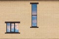 Two Windows of different shapes on the background of a light brick wall Fragment of the house wall for a design on a construction