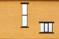 Two Windows of different shapes on the background of an orange brick wall Fragment of the house wall for a design on a