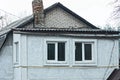 Two windows on a gray concrete wall of a rural house Royalty Free Stock Photo