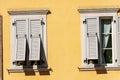 Windows with wooden grey shutters on orange wall - Trentino Italy Royalty Free Stock Photo