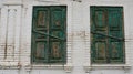 two window openings on the wall with closed shutters Royalty Free Stock Photo