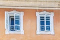Two windows on the wall of old medieval house in the historic center of Kranj, Slovenia Royalty Free Stock Photo