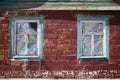 Two windows in wooden frame in red brick wall Royalty Free Stock Photo