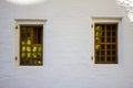 Two Windows with wooden shutters on the white stone wall of the medieval Novodevichy convent building Royalty Free Stock Photo