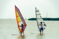 Two windsurfers on neusiedler lake in cloudy summer day