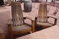 Two wine barrel chairs at a table at a winery with a wine barrel in the background Royalty Free Stock Photo