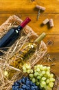 Two bottles with wine, grapes, corkscrew, cork on wooden backgr Royalty Free Stock Photo