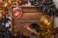 Two Wine bottles with grapes and wineglasses on old gray concrete table background with copy space. Red wine with a vine branch. Royalty Free Stock Photo