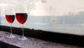 Two Wine glases on a background of old windows in abandoned house