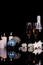 Two wine glasses with champagne, Christmas ornaments, gingerbread in the shape of stars and candle Royalty Free Stock Photo