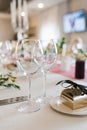 Two wine glasses are on the festive Banquet table and next to it is a box of sweets-bonbonniere