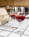 Two wine glasses filled with red wine, served on a white table in restaurant or bar. Royalty Free Stock Photo