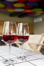 Two wine glasses filled with red wine, served on a white table in restaurant or bar. Royalty Free Stock Photo