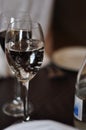 Two wine glasses filled with red wine, sparkling water or other drinks on a wooden table in a restaurant. Elegant dinner Royalty Free Stock Photo