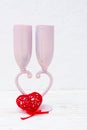 Two wine glasses form a heart-shaped legs and a red figured heart Royalty Free Stock Photo