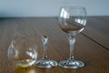 Two wine glasses. One half full broken glass and empty undamaged