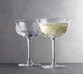 Two wine glasses with red wine close up on grey background Royalty Free Stock Photo